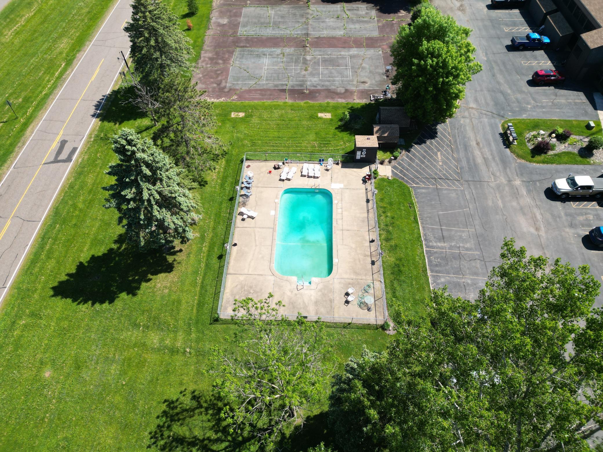 Aerial view of the pool area and tennis courts.