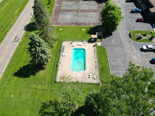 Aerial view of the pool area and tennis courts.