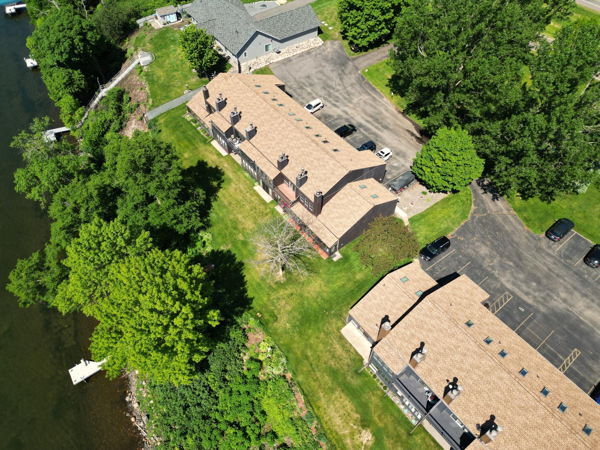Nicely wooded along the lakeshore. The assocation dock is just a few steps out the door of the three season porch.