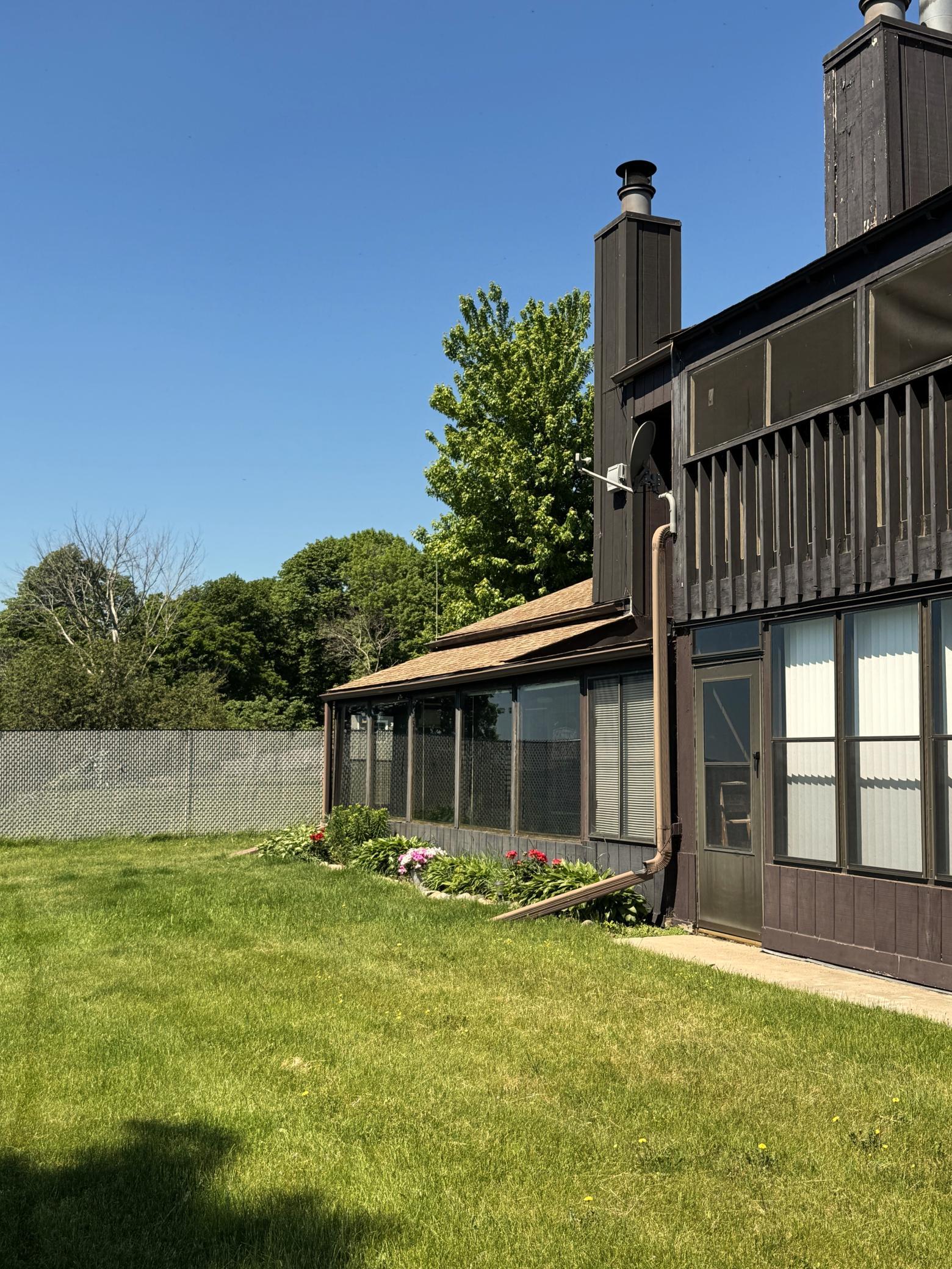 Ground view of the lake side of the condo. The open porch on the far side is for these two units. The exterior is maintained by the HOA.