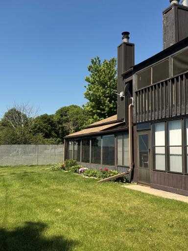 Ground view of the lake side of the condo. The open porch on the far side is for these two units. The exterior is maintained by the HOA.