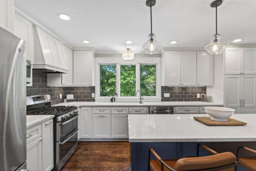 Enjoy cooking and gathering around the large center island with quartz countertops