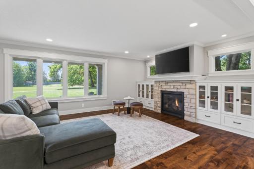 Cozy up in front of the gas fireplace, stone surround, and custom built-in cabinetry