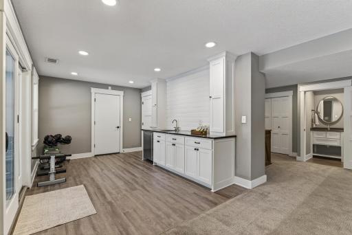 Convenient wet bar, space for workout gear and doorway to the tuck-under garage