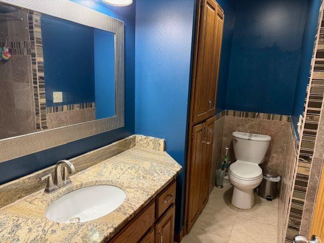 Full ceramic tiled bathroom with stone countertop