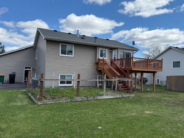 Access to fenced rear yard from Deck off Informal Dining Area, fenced garden area, paved play area and Utility Shed.