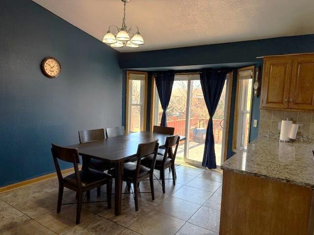 Spacious Informal Dining area has access to Deck and stairs to yard.
