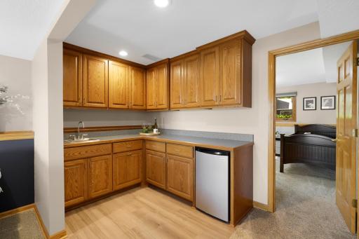 Nice wet bar located on the lower level. Sink and beverage fridge.