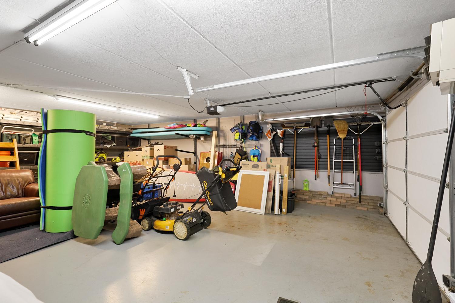 Spancrete lower level garage tucked under for all your lake like toys and storage needs