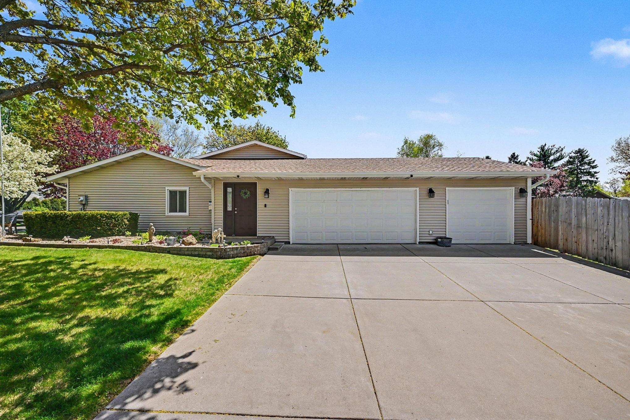 Three car garage with expansive concrete driveway