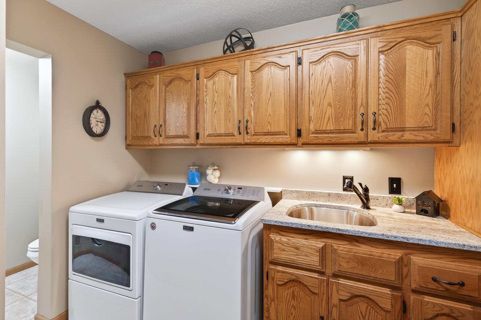 Main level laundry with custom granite countertops