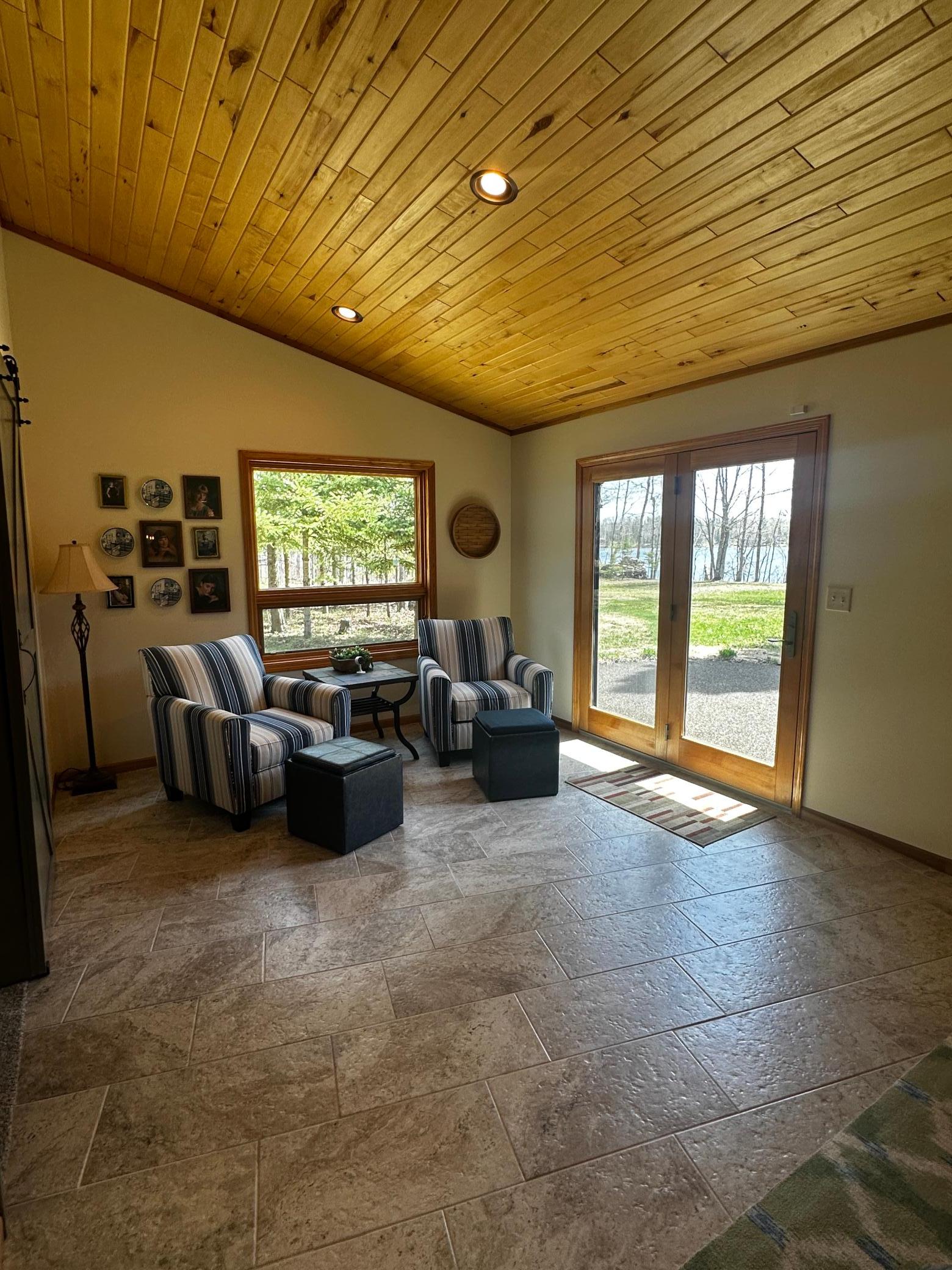 cozy sitting area with lake views and porous patio right outside.