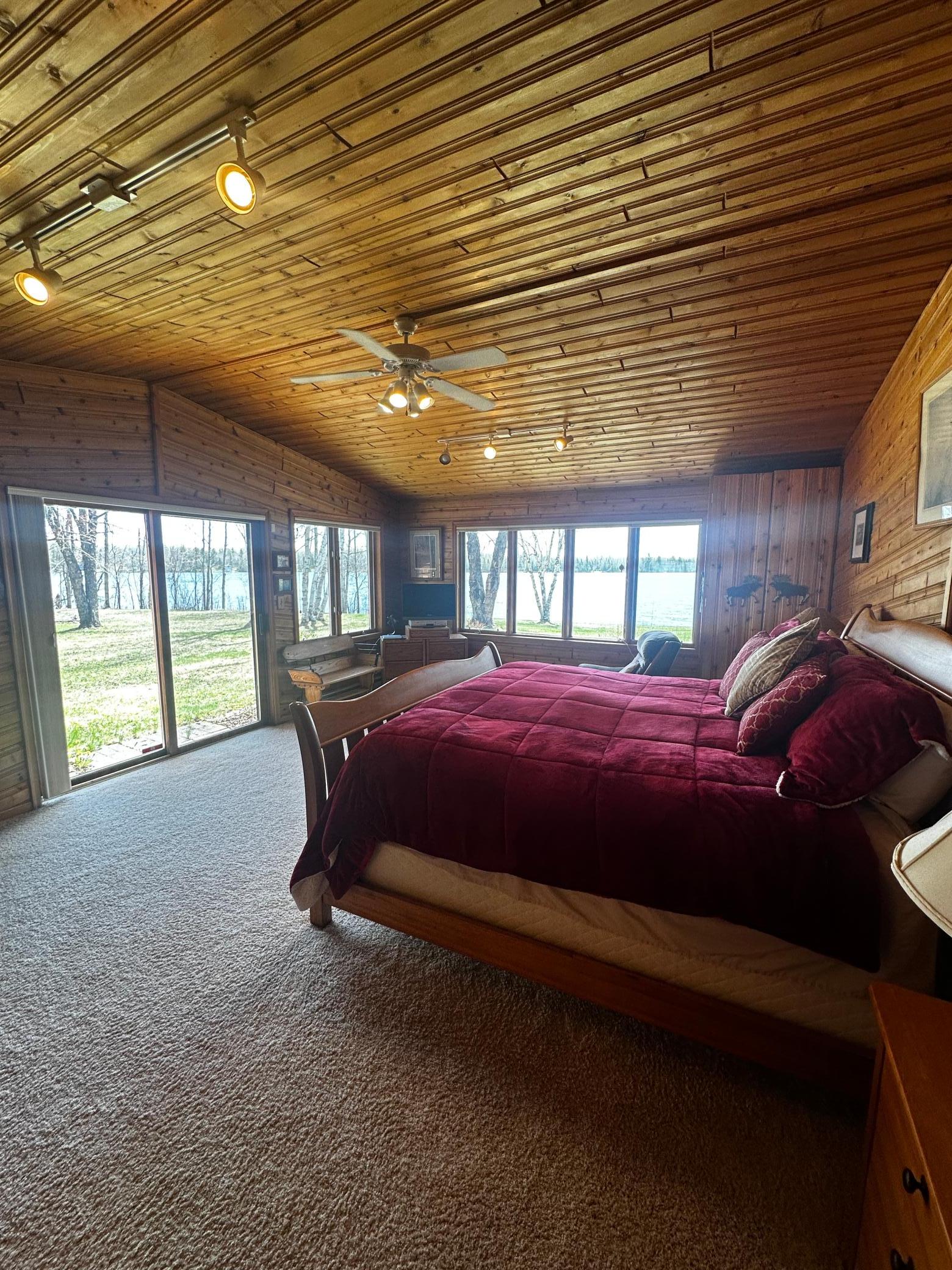 Primary ensuite features cedar tongue and groove, lake views, and outdoor access.