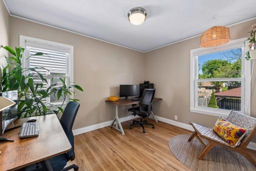 Bedroom 1 is currently used as an office. Great hardwood floors, new ceiling light and views of the backyard!