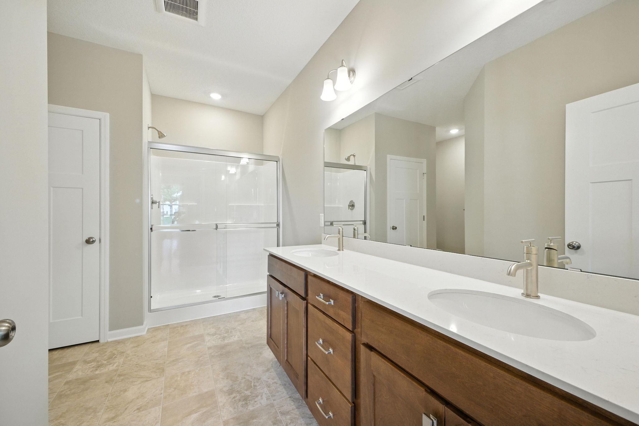 Owner's Bath, dual sinks, quartz countertops representational photo.