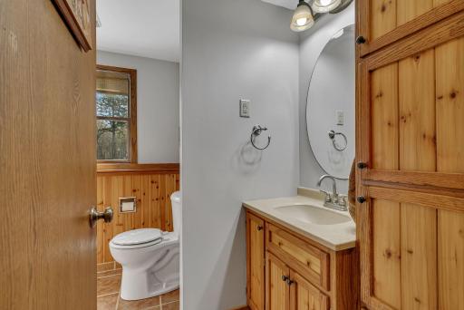 Basement 3/4 bath with tile walk in shower. tile floor, updated cabinetry, and sauna.