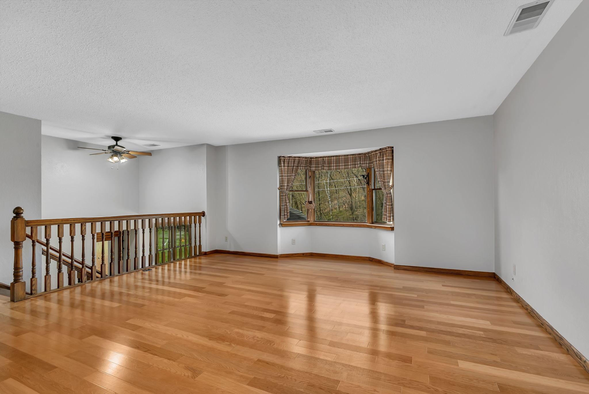 Spacious living room offering large bay window, engineered hardwood floors and is open to the foyer. This room is large spacious and bright! Ceilings and walls have been freshly painted.