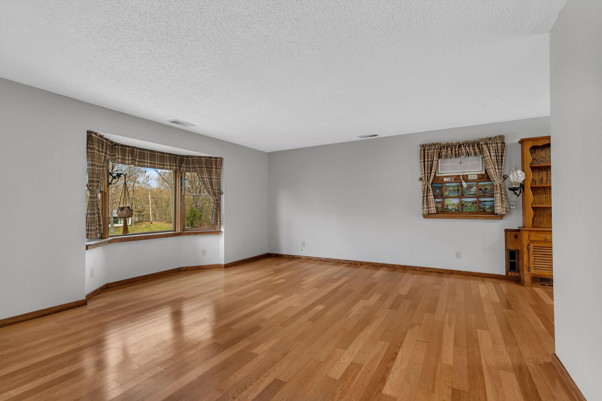 Another view of the living room area. This is a large space and has some wonderful views. Looking out the right side bay window you might even catch a glimpse of the lake!