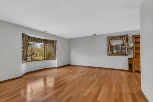 Another view of the living room area. This is a large space and has some wonderful views. Looking out the right side bay window you might even catch a glimpse of the lake!