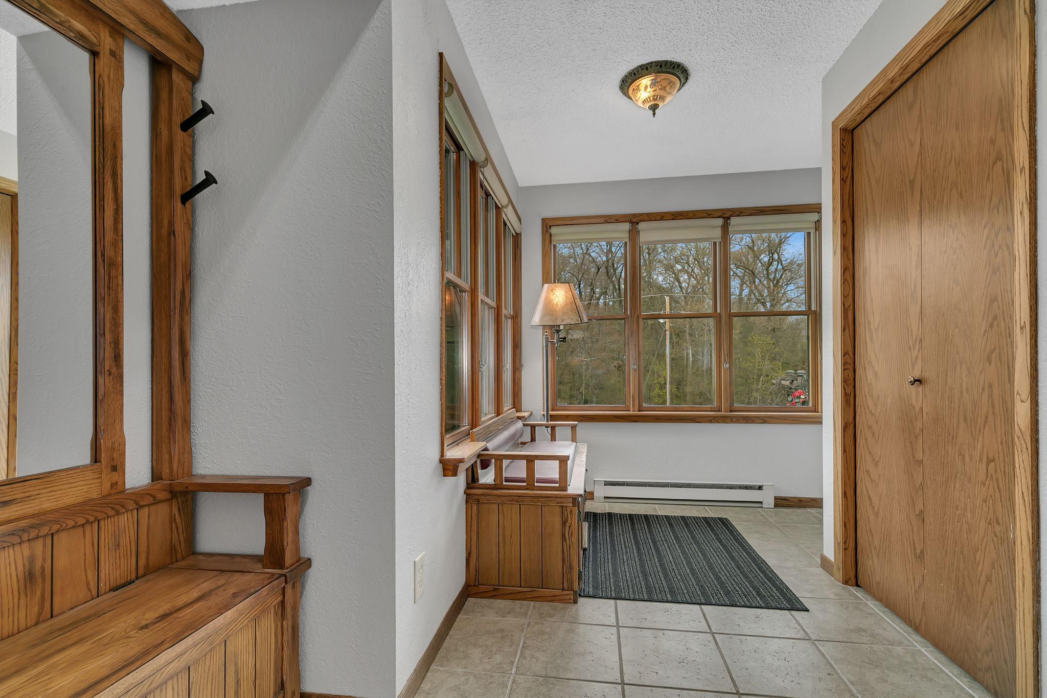 Foyer with built in benches, tile floors, large entry closet, large south & west facing windows.
