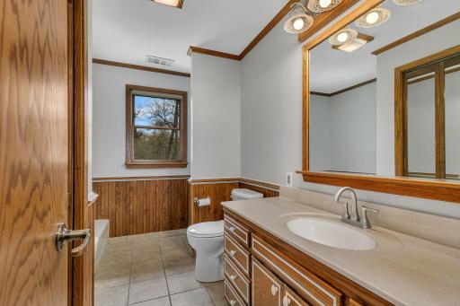 Main level 3/4 bathroom offers a large closet, bathtub and a urinal. Just another unique feature of this home.
