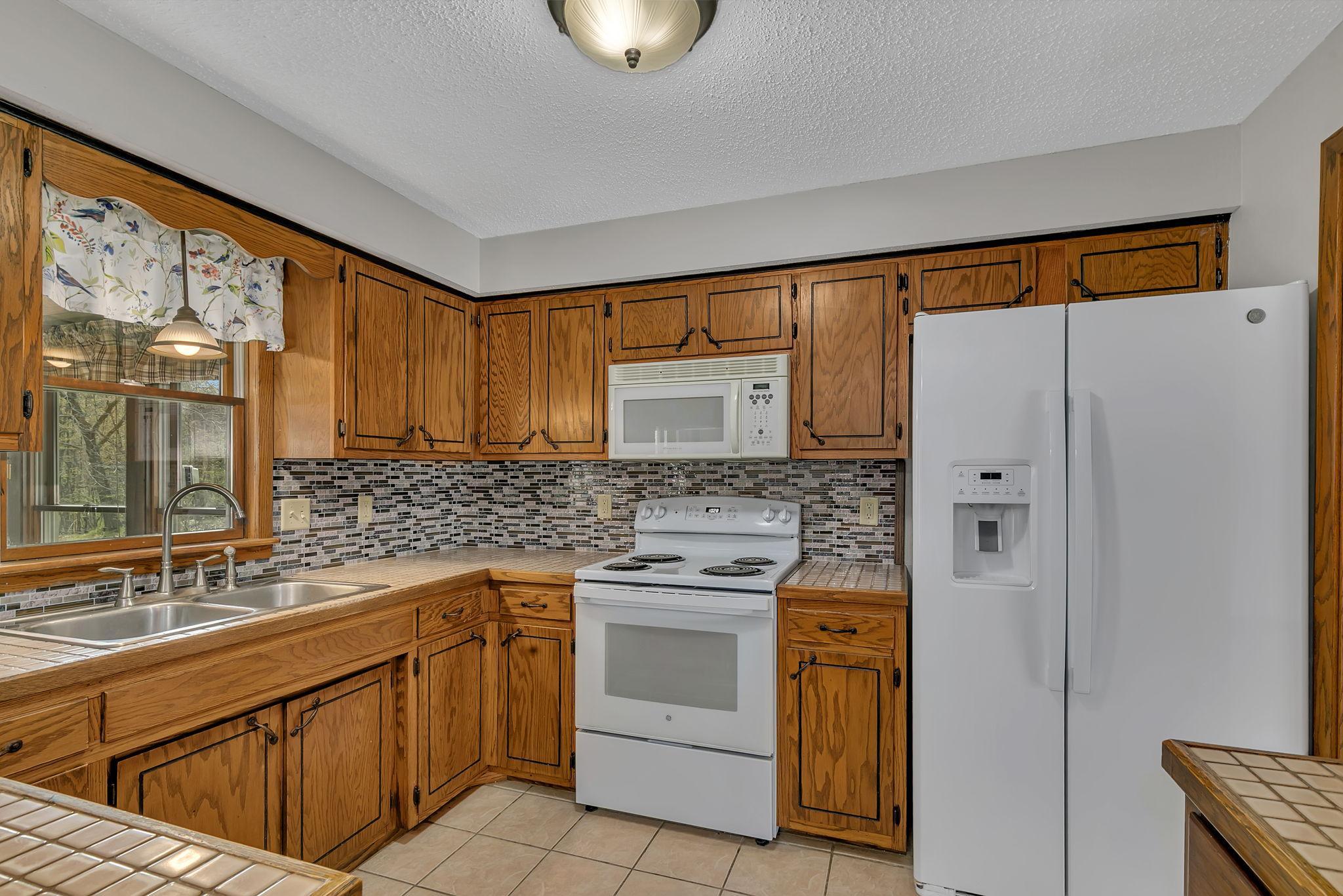 Another view of the kitchen showing just how much storage and prep space there is.