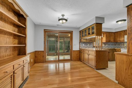 Nice bright dining room space just off of the kitchen. Patio doors lead to a wonderful 4 season porch. Kitchen offers tile floors, dining offers engineered hardwood floors. Built in cabinet is great for displaying decor.