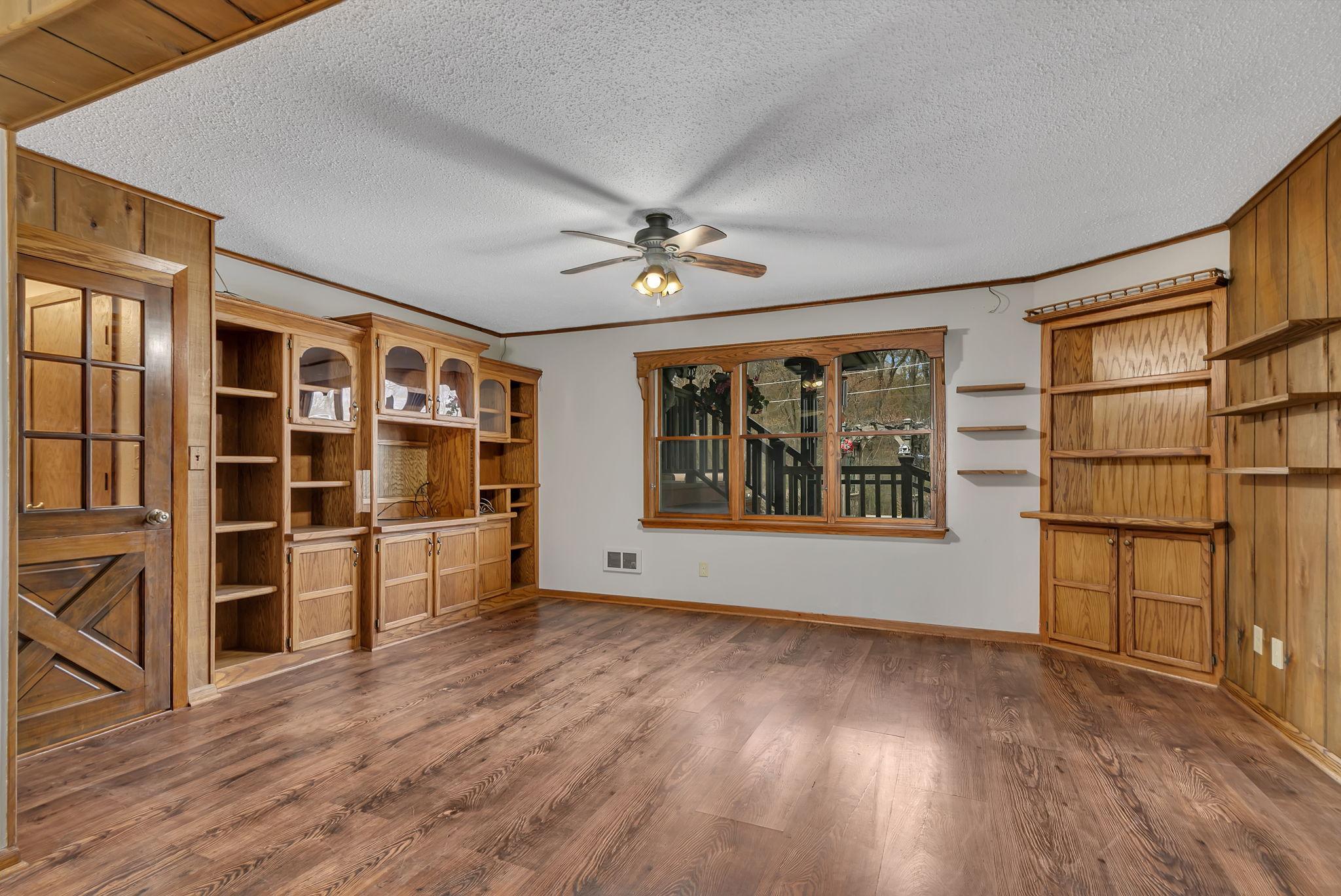 Family room area with built-ins and large windows. Large enough to fit a couple of couches or a combination of couch and chairs. Bring your ideas to make this your own! Fresh ceiling & wall paint.