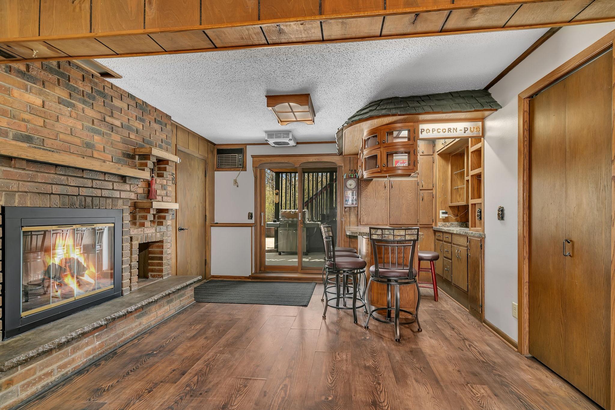 Welcome to the Popcorn Pub! This is one of those unique features that this home has to offer. Wood burning fireplace that currently has an electric insert. The bar area offers lots of cabinets for all your pub needs.