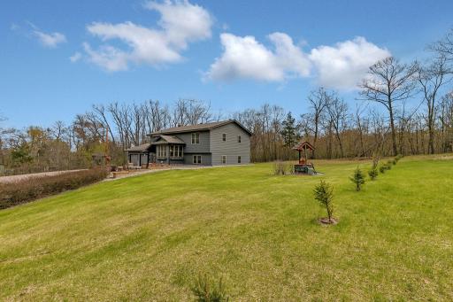 Situated on 1.1 acres, offering enough elbow space to enjoy the outdoors. The property line is approx 10 ft on the other side of the row of small trees (towards the house)