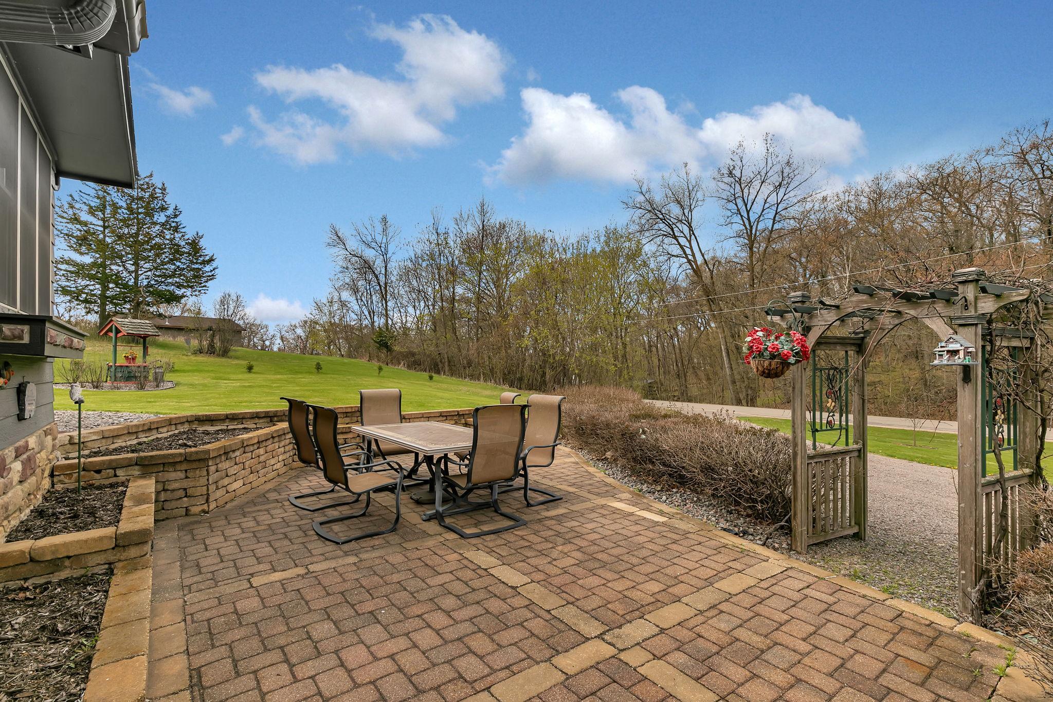 The front paver patio is an amazing space to spend time and enjoy some raised bed gardening. The hedges are lilacs and are simply amazing in the summer!
