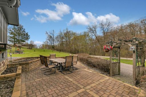 The front paver patio is an amazing space to spend time and enjoy some raised bed gardening. The hedges are lilacs and are simply amazing in the summer!