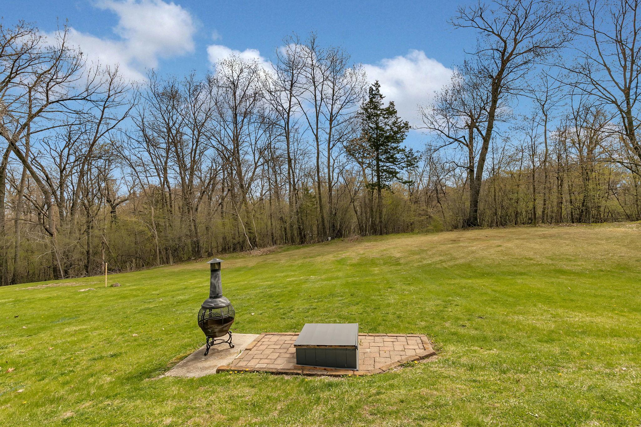 Spacious backyard with a separate little patio area.