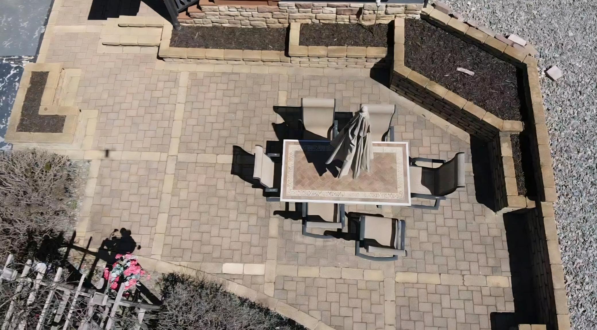 Beautiful front paver patio with raised gardens. With your favorite plants all in full bloom, this area becomes a sanctuary.
