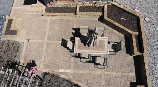 Beautiful front paver patio with raised gardens. With your favorite plants all in full bloom, this area becomes a sanctuary.