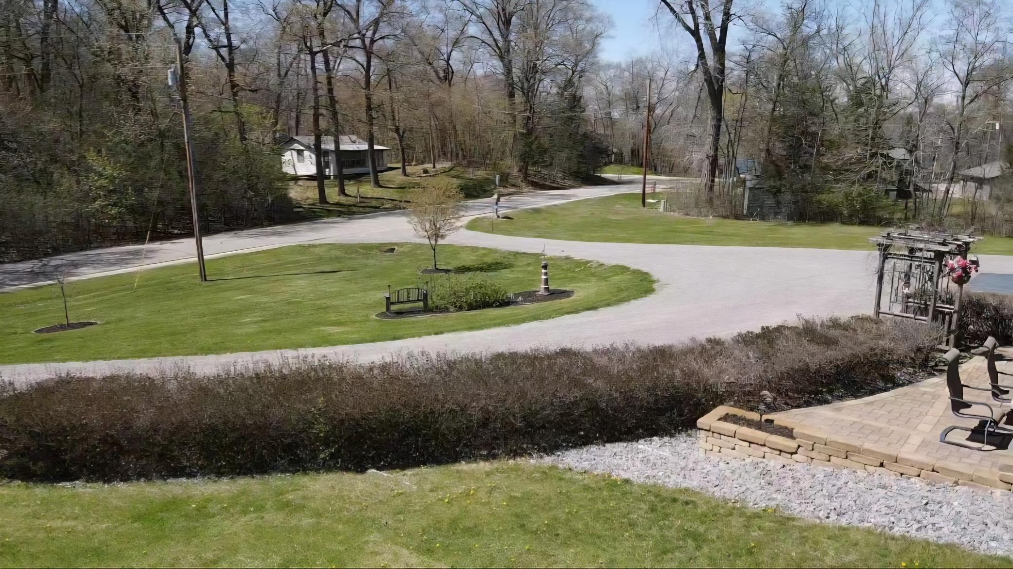View towards the road. Just down from the driveway is where your lake fun begins. Look closely, you can see the lake through the trees.