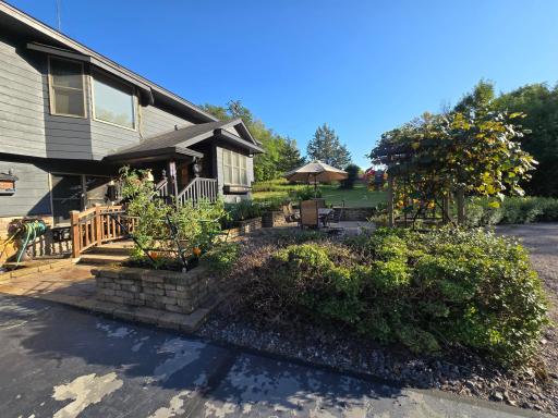 Large front paver patio is secluded by the dwarf lilac bushes.