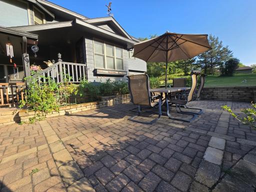 The front paver patio is an amazing space to spend time and enjoy some raised bed gardening. The hedges are lilacs and are simply amazing in the summer!