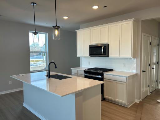 Stunning kitchen with Quartz countertops and stainless steel appliances