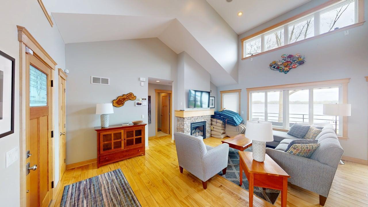 Vaulted ceilings, hardwood floors, and a cozy fireplace create a warm and inviting welcome as you enter the home.