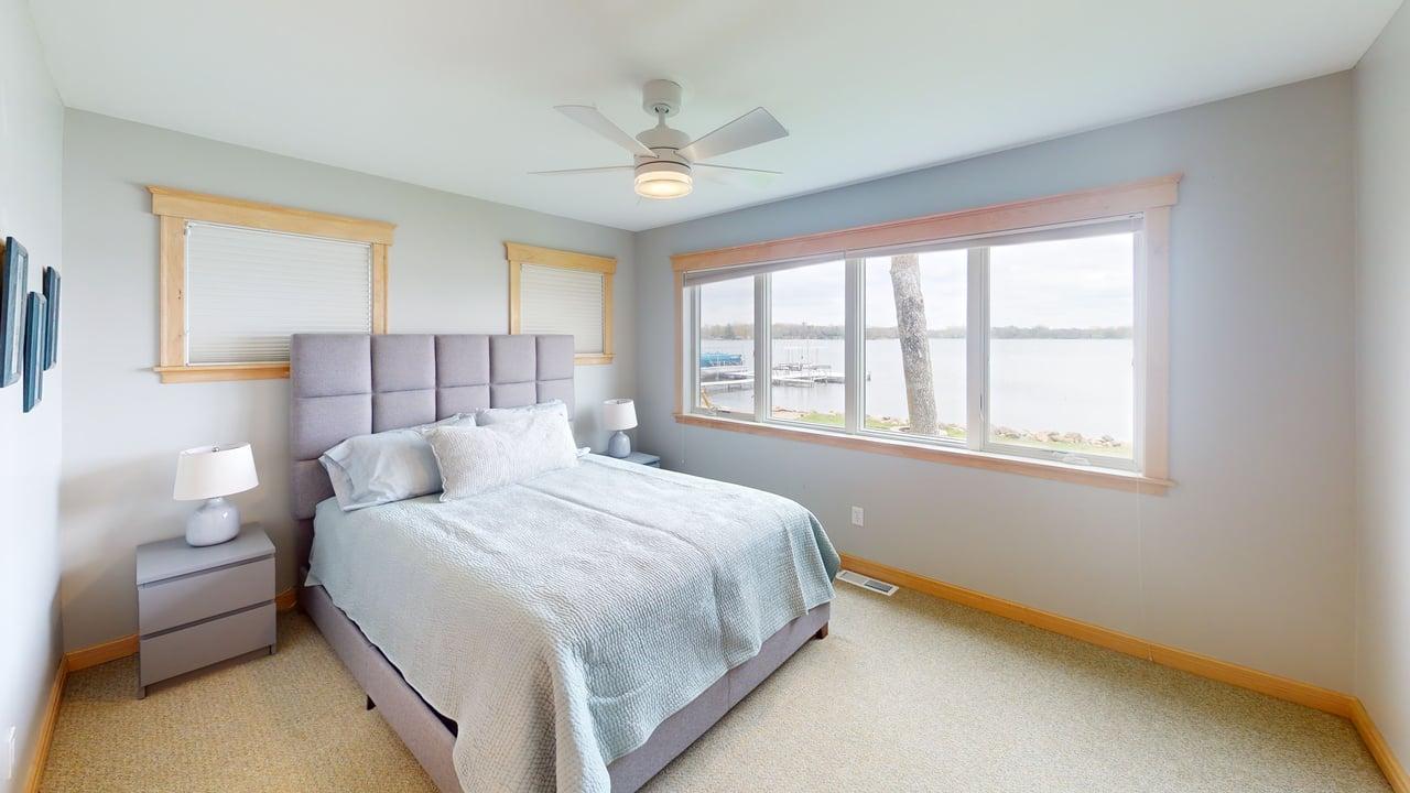 Bedroom 2 on the main level is lakeside, allowing you to wake up to gorgeous views.