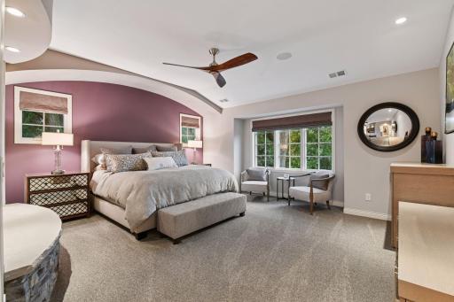 Upper-level Primary Suite offers lake views, 2-sided gas fireplace, 2 Primary Bathrooms with in-floor heat and 2 Primary walk-in closets