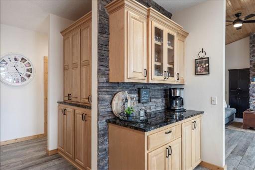 Beverage area with stone back splash.Note the spacious pantry to the side.