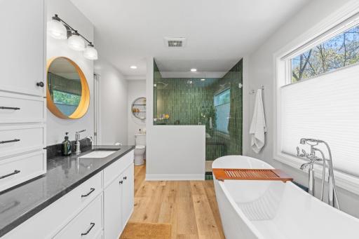 Fully renovated primary en-suite bathroom complete with soaking tub and large walk-in shower.jpg