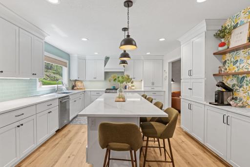 Renovated kitchen with new gas stove and exhaust hood