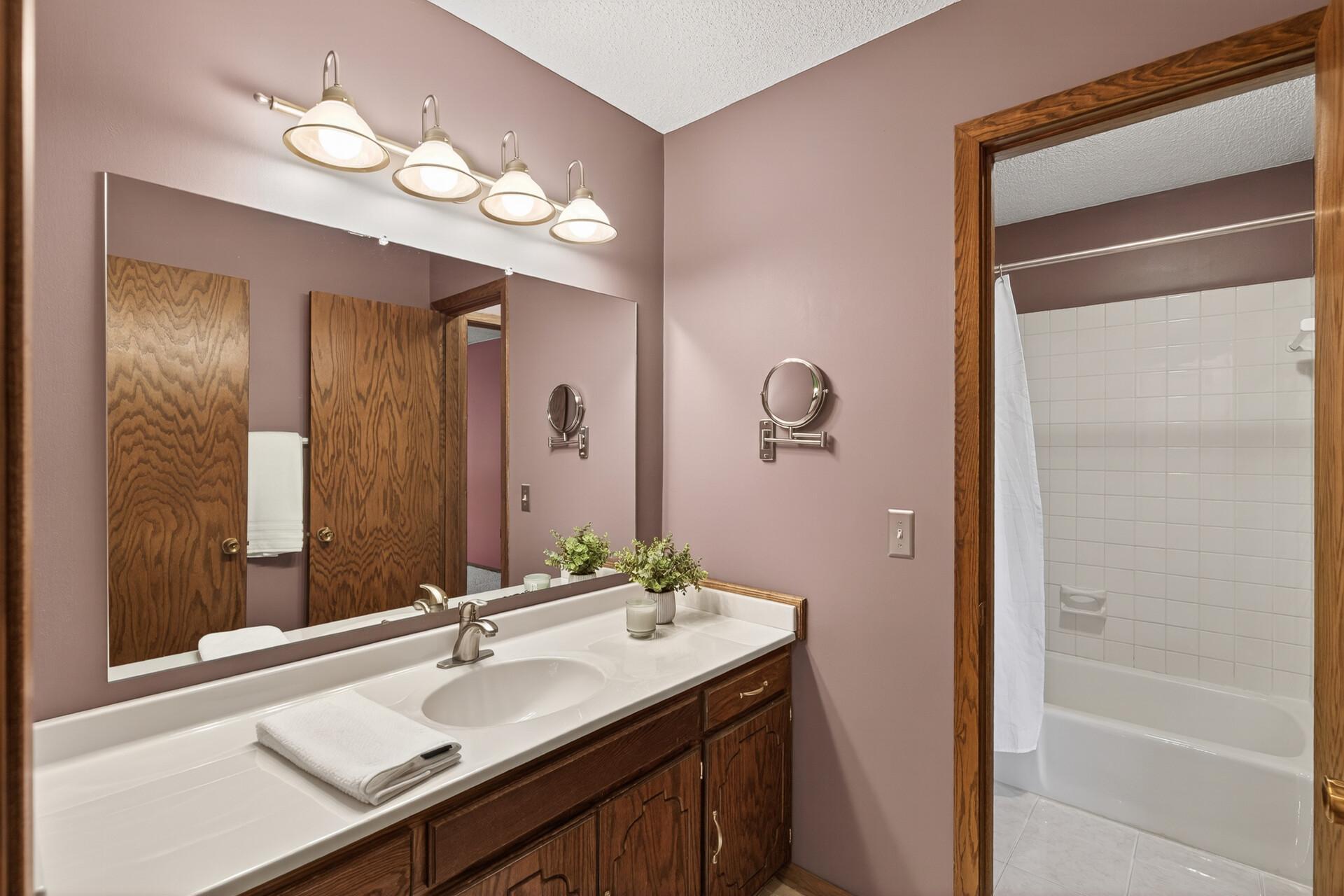 Main floor walk through bathroom has separation of sink from tub/toilet area.