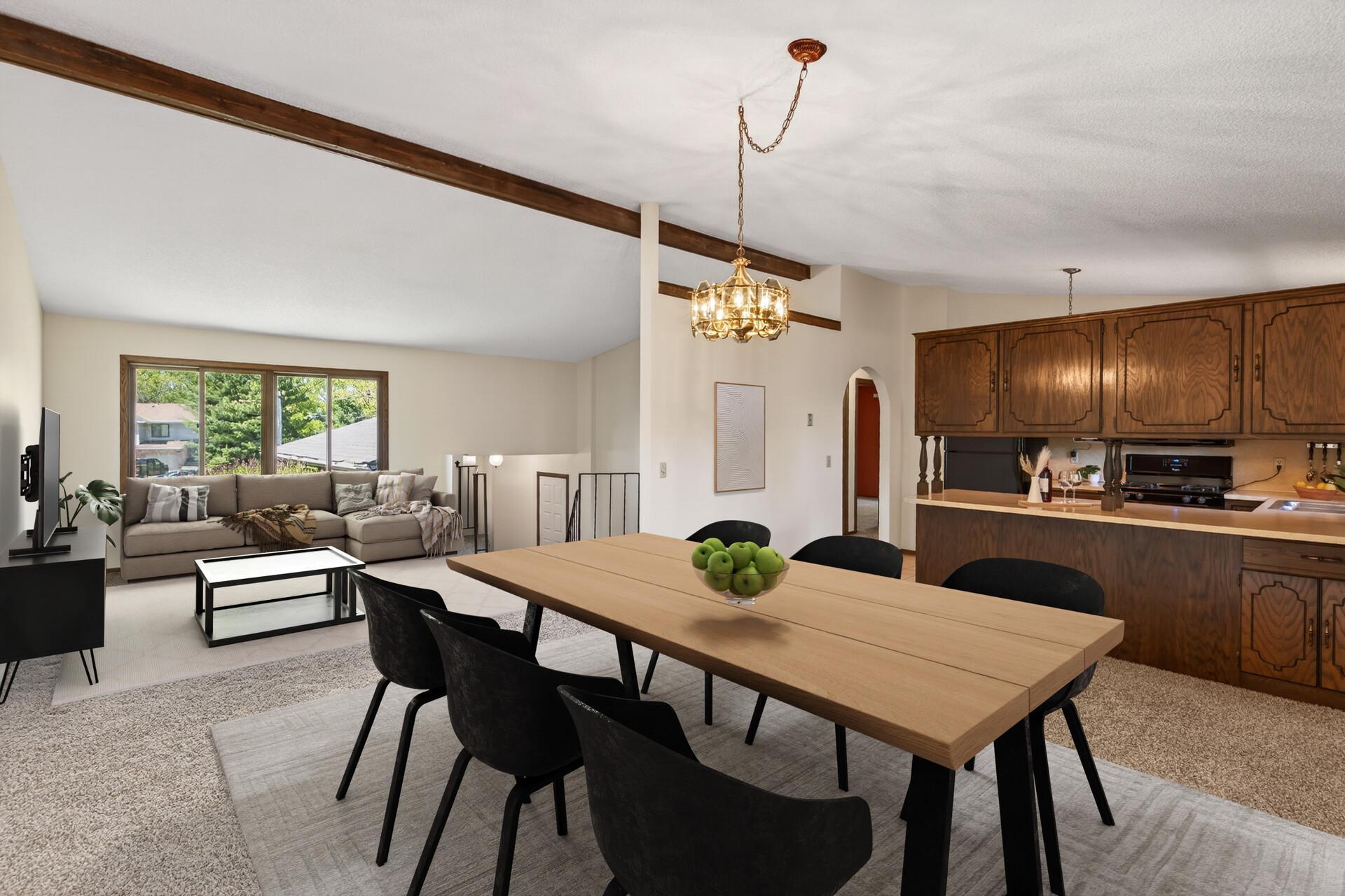 Virtually staged view of dining room, living room and kitchen