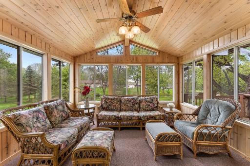 This amazing porch features vaulted ceilings, knotty pine interior, double pane windows and access the deck.