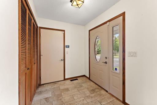 Main entrance with tile floors, large coat closet and garage access
