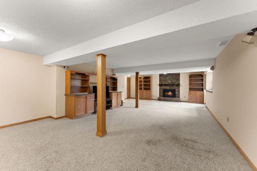 Spacious family room that features a gas burning fireplace, built in shelves and walk-out!